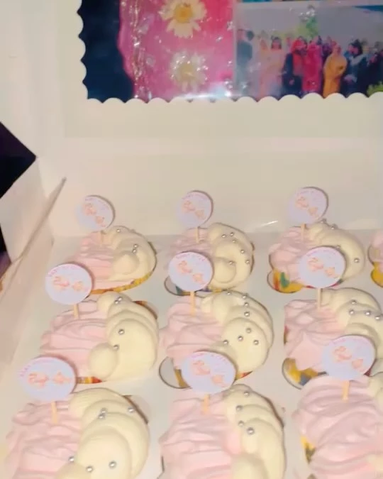 Delicious gender reveal cupcakes on white tray with pink cream and yellow frosting for baby celebration - Party Cupcakes Karachi By Whisk And Sift